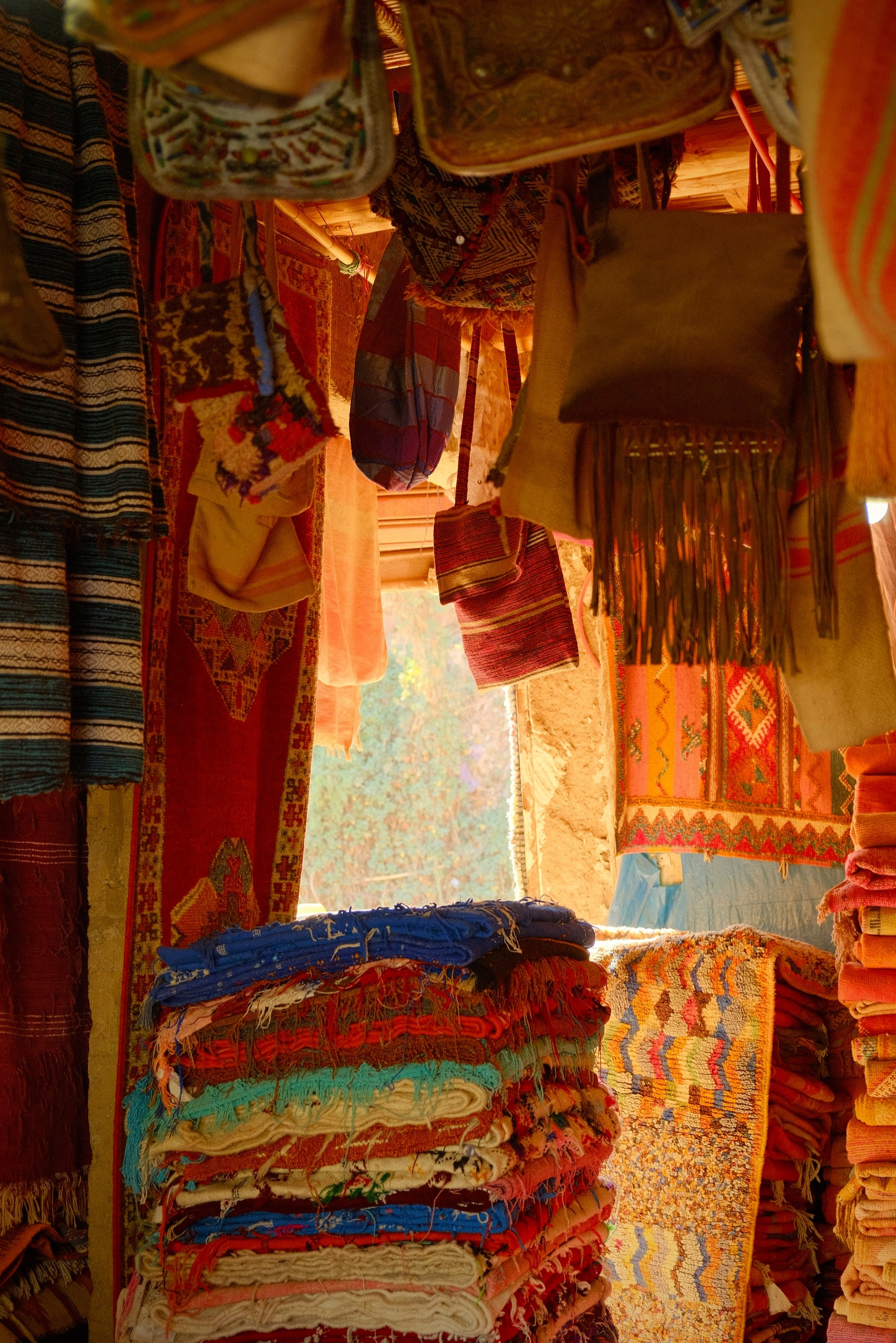 Layer upon layer of textile and lantern in a Marrakech souk, the depth of the market pressed into a single frame