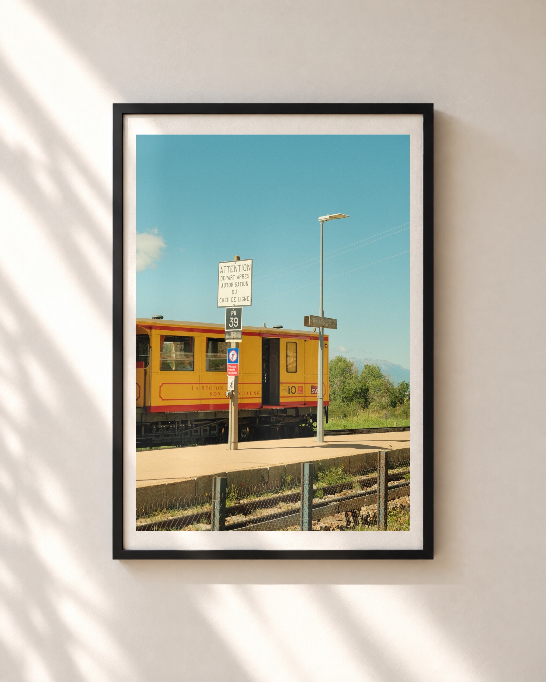 Yellow Train, Halt, framed print shown on a wall